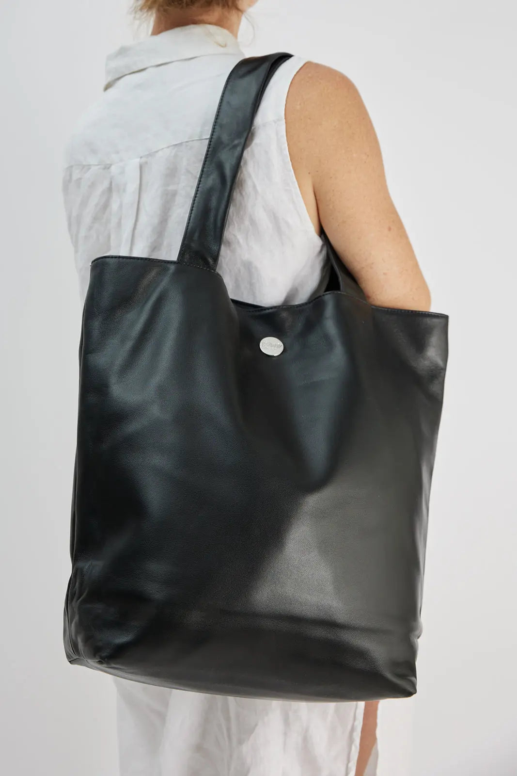 The I Appreciate Me black lambskin leather tote worn on shoulder